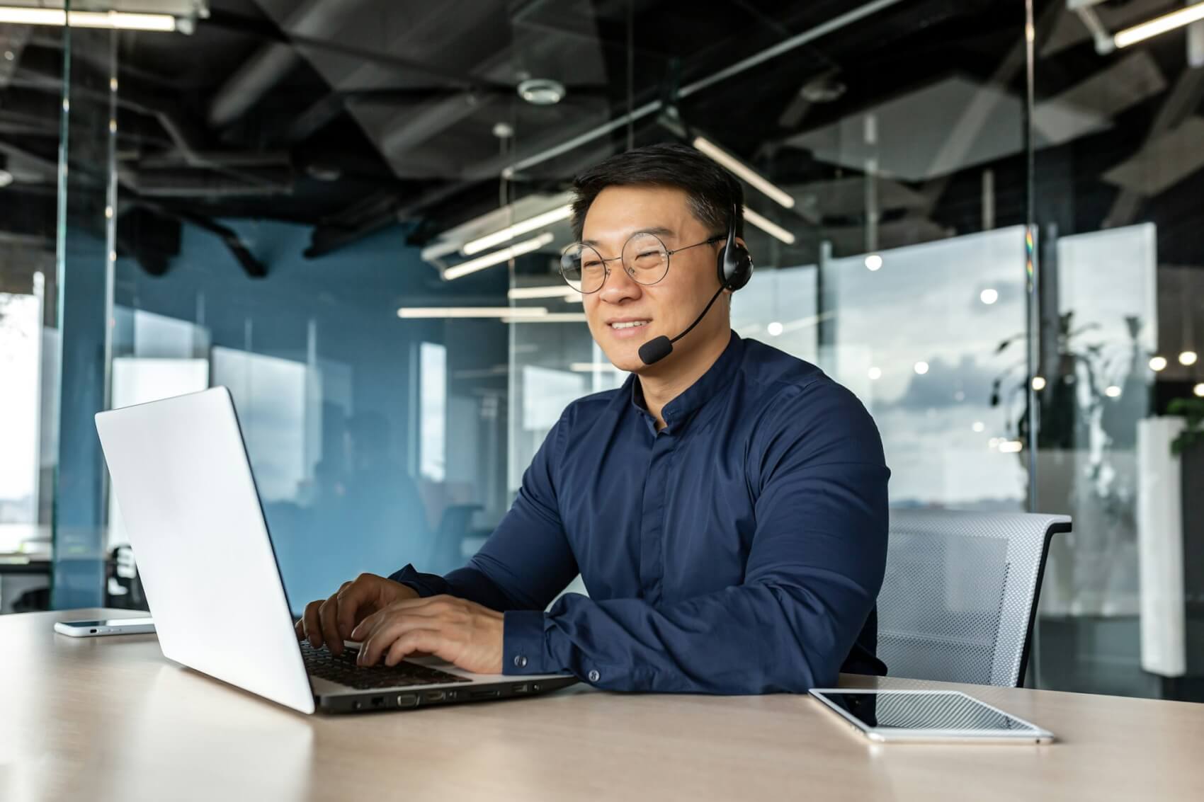 happy-and-smiling-worker-with-headset-for-video-call-asian-tech-support-man-talking-to-online.jpg