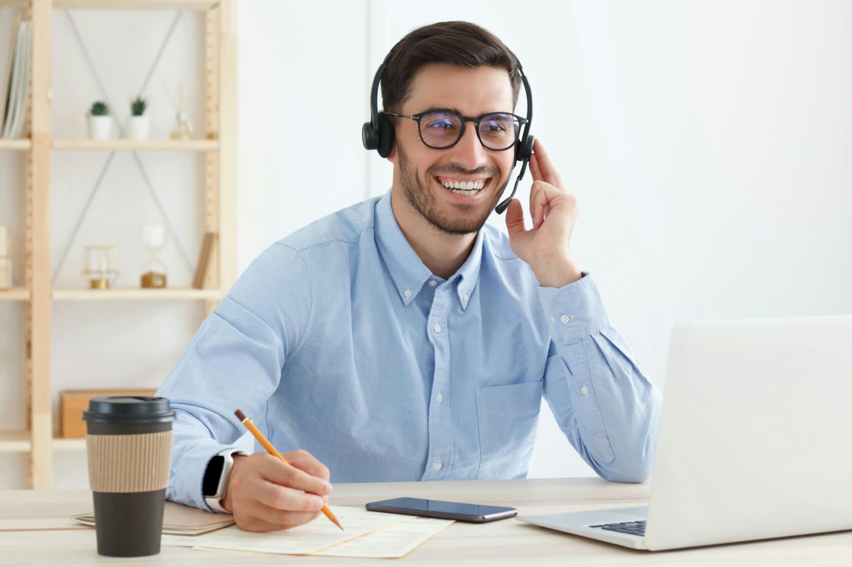 smiling-customer-support-service-operator-with-hands-free-headset-working-in-office.jpg